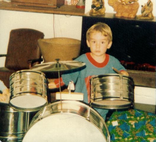 Randy as a toddler behind a small chrome drum kit